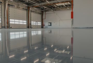 Technician applying seamless epoxy coating to a residential garage floor in Chanhassen for a clean, durable finish.