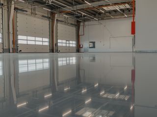 Technician applying seamless epoxy coating to a residential garage floor in Chanhassen for a clean, durable finish.