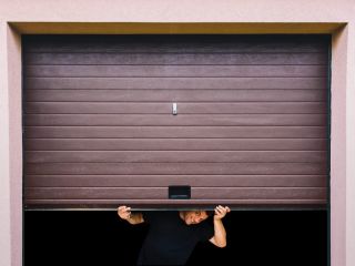 Chanhassen Garage Door Maintenance Service Technician performing garage door maintenance and safety inspection on a residential garage door in Chanhassen.